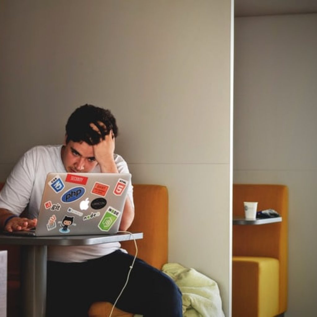 Man feeling stress working on computer and website